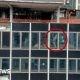 A NYC high-rise building has broken structural beams. In the image, one broken beam is circled in red.
