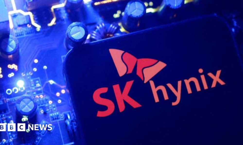 A screen displaying the SK Hynix logo posed above a computing motherboard