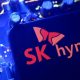 A screen displaying the SK Hynix logo posed above a computing motherboard