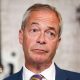 Nigel Farage in a close-up, wearing a blue suit, white shirt and stripe tie.