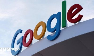Google's primary-colored logo outside of a building.