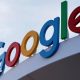 Google's primary-colored logo outside of a building.