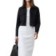 A woman wearing a black blazer, white top, white skirt, and carrying a black handbag