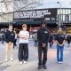 Bite Back campaigners in front of anti junk food ad on billboard