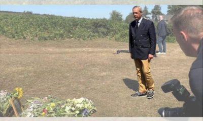 Nigel Farage laying a wreath in a field