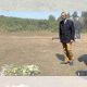 Nigel Farage laying a wreath in a field