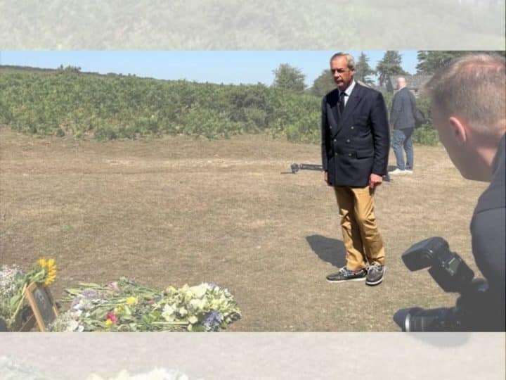 Nigel Farage laying a wreath in a field