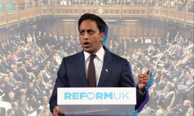Zia Yusuf at a Reform-branded podium speaking with an image of a packed House of Commons behind him