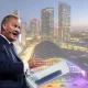 Rupert Lowe of Restore Britain and a scene of Manchester city centrescape with vibrant infrastructure in the background