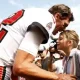 GettyImages-1427328428-Tom-Brady-Passes-Olympic-Torch-to-Daughter-Vivian-Lake-After-Ruling-Out-His-Own-Bid