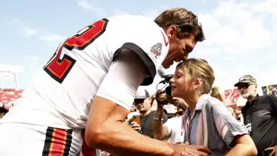 GettyImages-1427328428-Tom-Brady-Passes-Olympic-Torch-to-Daughter-Vivian-Lake-After-Ruling-Out-His-Own-Bid