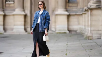 PARIS, FRANCE - MAY 25: Marissa Cox wears an Arket black skirt, an Arket white t-shirt, a blue oversize Agolde denim jacket, ATP Atelier pale pastel yellow flats / shoes, a white Arket leather bag, Jimmy Fairly x Reformation sunglasses, and Alighieri necklace, during a street style fashion photo session, on May 25, 2024 in Paris, France. (Photo by Edward Berthelot/Getty Images)