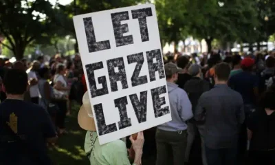 At the Great March for Gaza 2026 someone holds a placard saying 'Let Gaza Live'