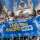Protesters against greyhound racing hold a banner saying End Dog Racing Now