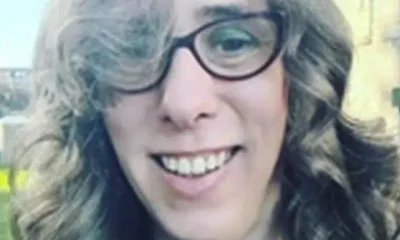 Close up selfie of Heather Herbert, who wears cat eye shaped glasses and has bouncy curls in her hair, and made mean comments online about Ann Widdecombe dying