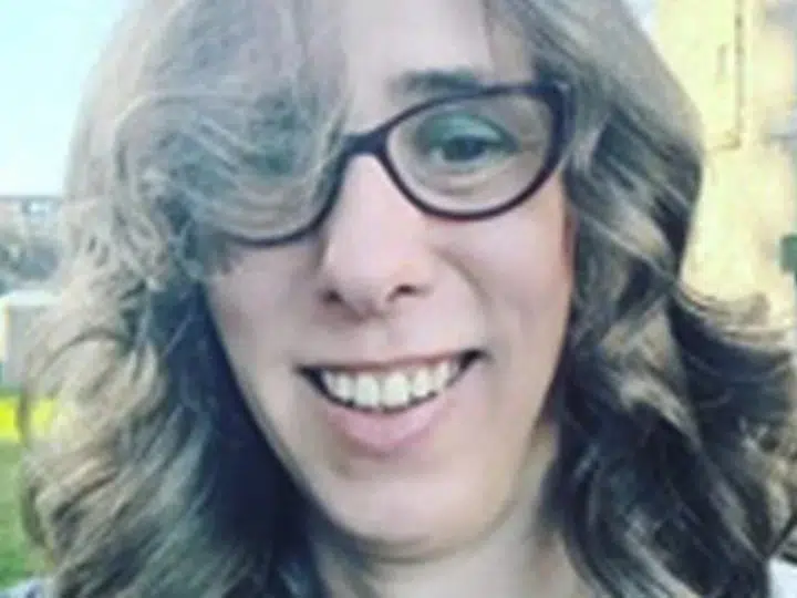 Close up selfie of Heather Herbert, who wears cat eye shaped glasses and has bouncy curls in her hair, and made mean comments online about Ann Widdecombe dying