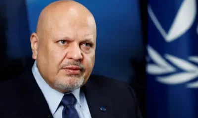 Karim Khan, ex-ICC prosecutor, who has a bald head and piercing eyes, looks stern as he stares into the distance