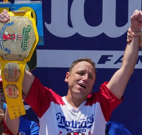 Eating champion Joey Chestnut defends title but blames heat for lower hot-dog tally