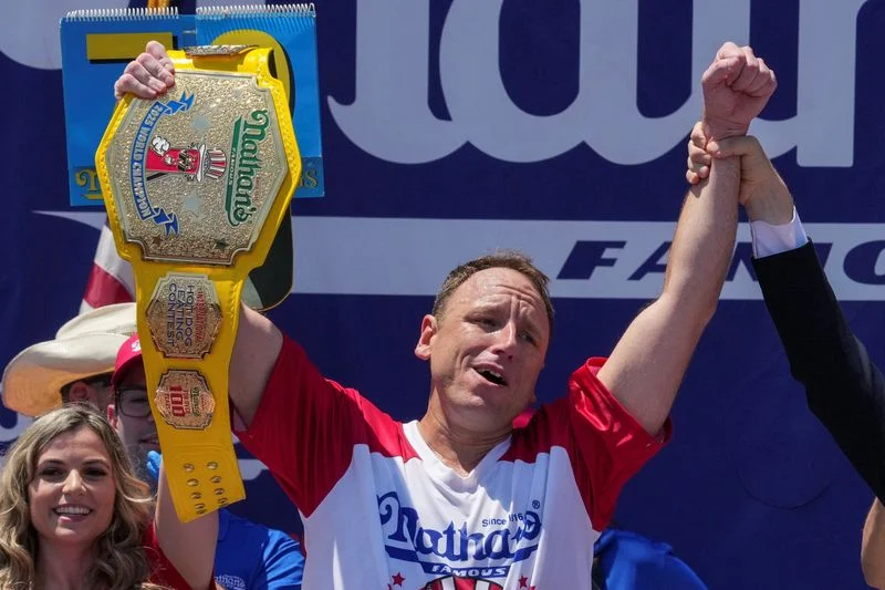 Eating champion Joey Chestnut defends title but blames heat for lower hot-dog tally