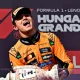 Lando Norris celebrates on the podium with a trophy after winning the Hungarian Grand Prix
