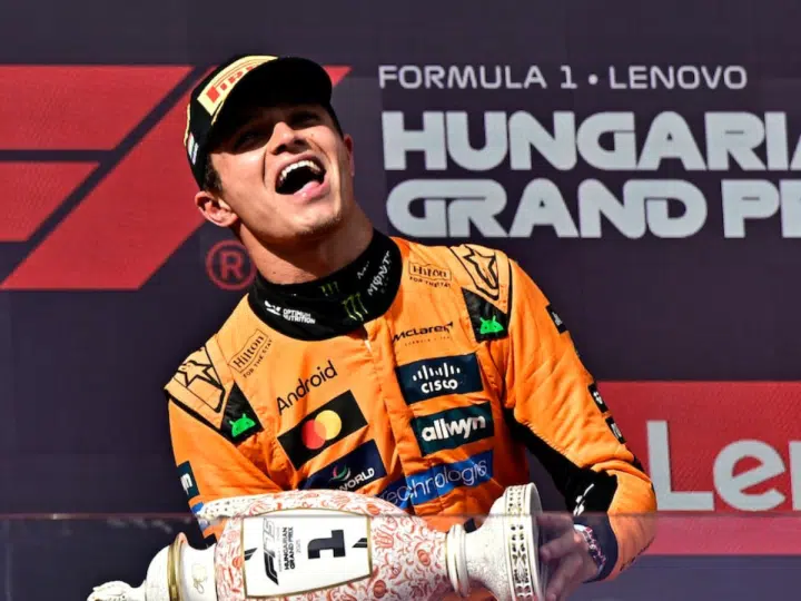 Lando Norris celebrates on the podium with a trophy after winning the Hungarian Grand Prix