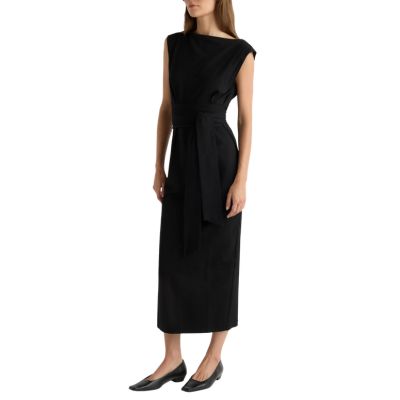 A woman wearing a black dress and low black heels
