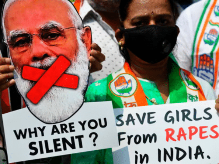 An activist holds a cut-out of the prime minister of India, Narendra Modi, at a protest over another gang-rape and murder of a young woman in Uttar Pradesh state in 2020