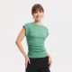 A woman wearing a light green, ruched top and black shorts