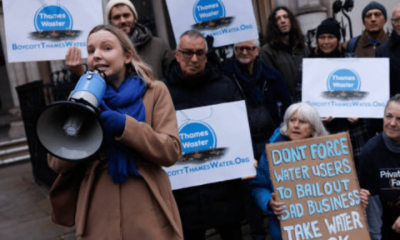 Thames Water protestors outside with megaphones and one placard that reads: 'Don't force water users to bail out bad business. Take water back'.