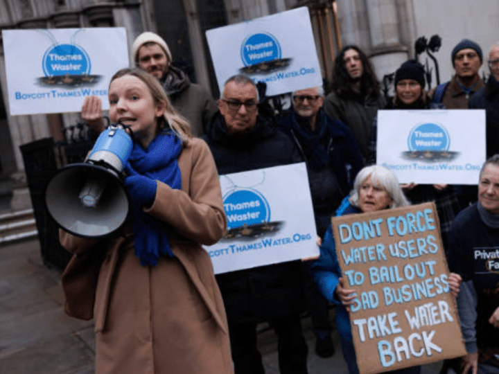 Thames Water protestors outside with megaphones and one placard that reads: 'Don't force water users to bail out bad business. Take water back'.