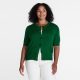 A woman wearing a green short-sleeved cardigan, white top, and white pants