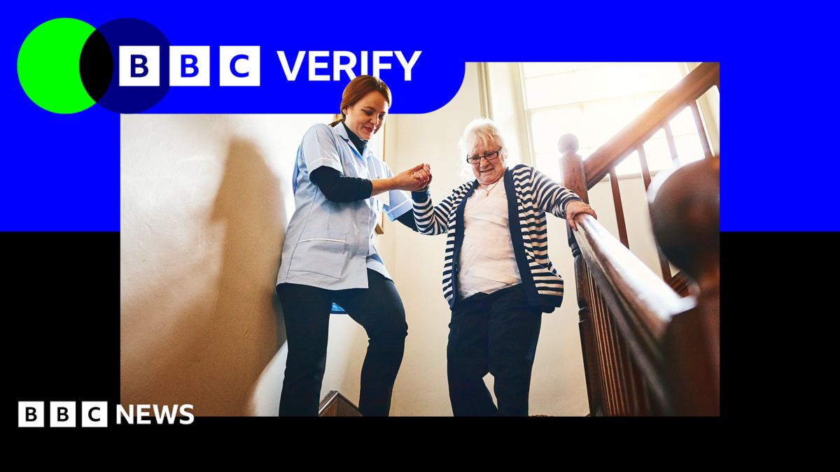 A care worker helps a woman down a flight of stairs