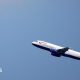 A British Airways Airbus A320 flies up through a blue sky.