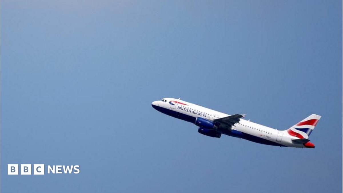 A British Airways Airbus A320 flies up through a blue sky.