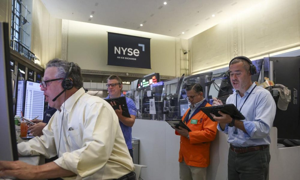 Wall St falls as chip weakness offsets solid earnings