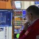 Wall St ends mixed as investors focus on tech earnings