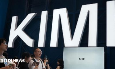 Visitors at a trade show in Shanghai visit a booth with the Kimi sign displayed in large block letters