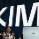 Visitors at a trade show in Shanghai visit a booth with the Kimi sign displayed in large block letters