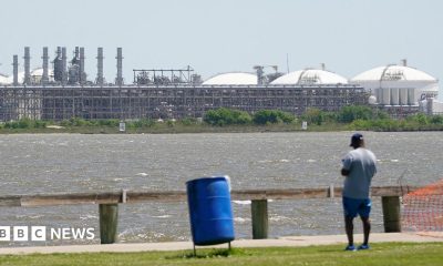 A man stares across the bay from the vast Sabine Pass LNG export terminal, the world's largest