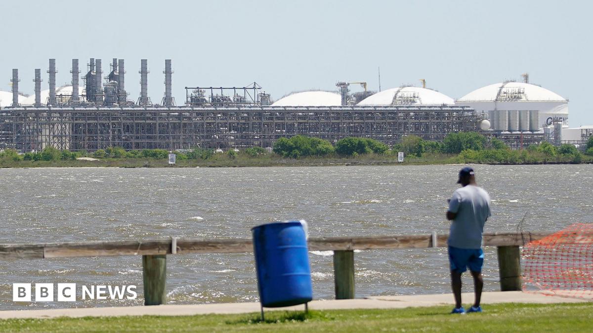 A man stares across the bay from the vast Sabine Pass LNG export terminal, the world's largest