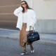 BERLIN, GERMANY - MAY 27: Lisa Mottl is seen wearing an off-white double-breasted oversized blazer with sharp wide peak lapels, padded shoulders, long sleeves, two parallel rows of matching fabric-covered buttons and classic horizontal flap pockets from Bazhane; a white fitted top from Zara; camel brown cargo-inspired cropped capri length trousers with belt loops, angled flap pockets, wide fluid legs and adjustable drawstring toggle hems creating a gathered balloon-like silhouette from Zara; off-white leather