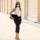 BERLIN, GERMANY - JULY 03: Aylin Sengül wears black capri pants Massimo Dutti, white sleeveless top Almada Label, heels Mango, sunglasses Chanel, bag Cos during the Berlin Fashion Week Spring/Summer 2026 at on July 03, 2026 in Berlin, Germany. (Photo by Christian Vierig/Getty Images)