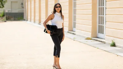 BERLIN, GERMANY - JULY 03: Aylin Sengül wears black capri pants Massimo Dutti, white sleeveless top Almada Label, heels Mango, sunglasses Chanel, bag Cos during the Berlin Fashion Week Spring/Summer 2026 at on July 03, 2026 in Berlin, Germany. (Photo by Christian Vierig/Getty Images)