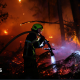 A firefighter works at the scene of a wildfire, in Andernos-les-Bains in the Gironde department, amongst worsening drought conditions following a heatwave and water shortages across much of France, July 26, 2026