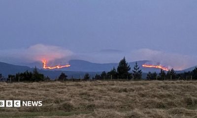 Stretch of mountains in the Cairngorms with wildfires burning across a large area