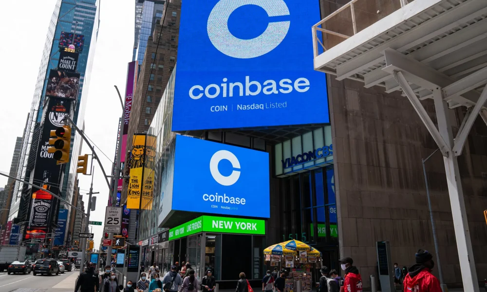 Coinbase advertising sign in Times Square, New York with pedestrians.