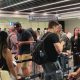 People move through the queue for the Entry Exit System process at Fuimicino Airport in Rome, Italy.