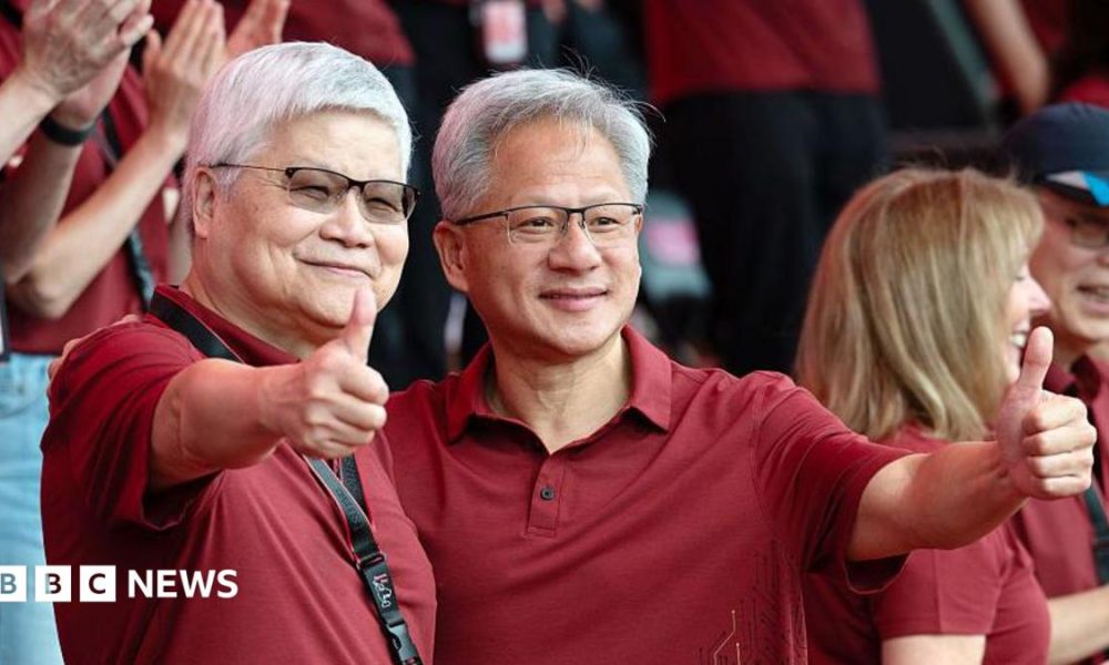 Jensen Huang, chief executive officer of Nvidia (right), poses for photographs with TSMC boss CC Wei smiling with their thumbs up. Both men are dressed in red polo t-shirts