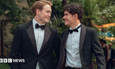 Production still from Heartstopper Forever showing Kit Connor and Joe Locke smiling at each other in tuxedos