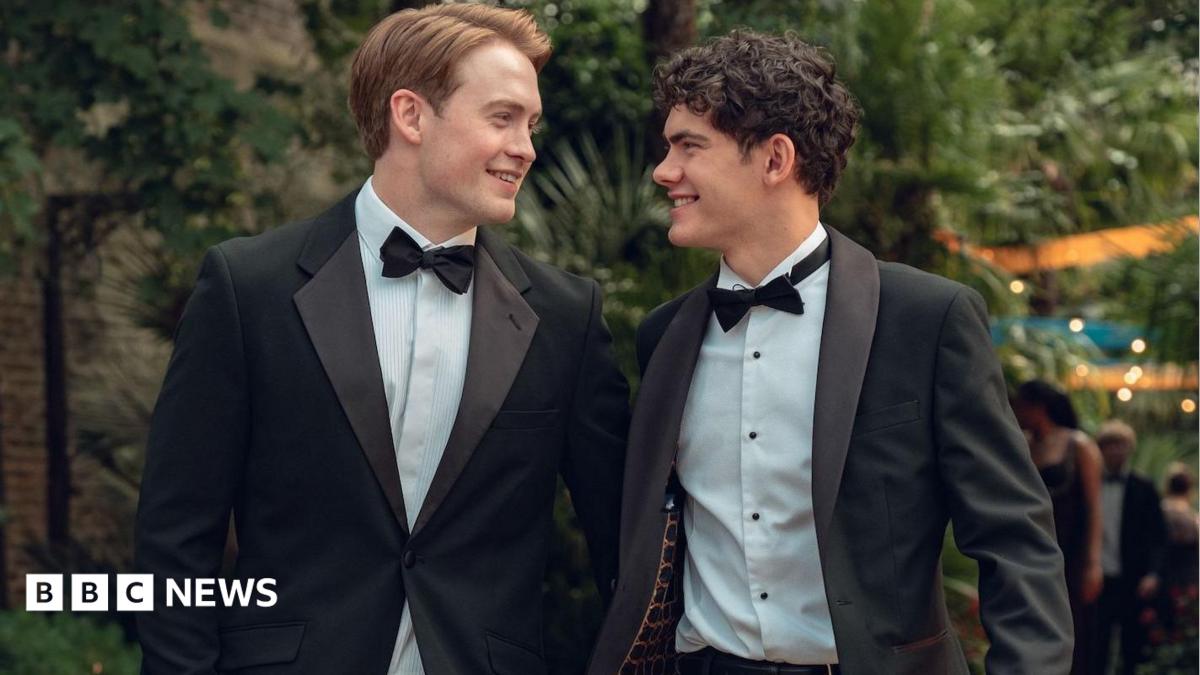 Production still from Heartstopper Forever showing Kit Connor and Joe Locke smiling at each other in tuxedos
